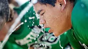 Student athlete cooling off with water